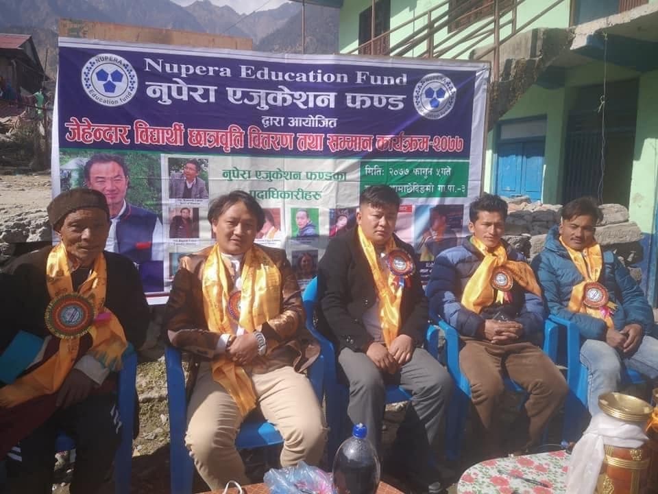 Guests seated beneath a Nupera Education Fund banner at the scholarship ceremony
